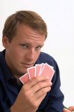 Upclose portrait of a man playing poker.