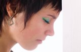 Horizontal sad young woman expressing anxiety leaning against wall