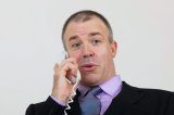 Businessman having animated conversation on telephone