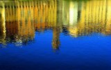 "Lungarno Reflections": Buildings of Oltrarno are reflected in the Arno on a bright Spring Day