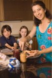 Portrait of mother making lunch for kids